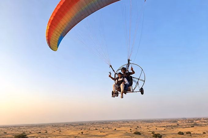 Two-person paramotoring flight above the Jaisalmer desert