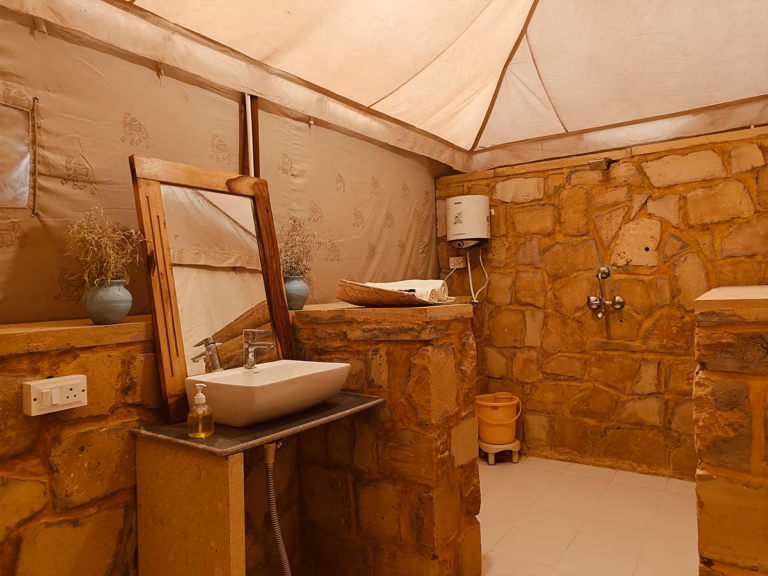 Attached bathroom with washbasin and shower in the Luxury Swiss Tent