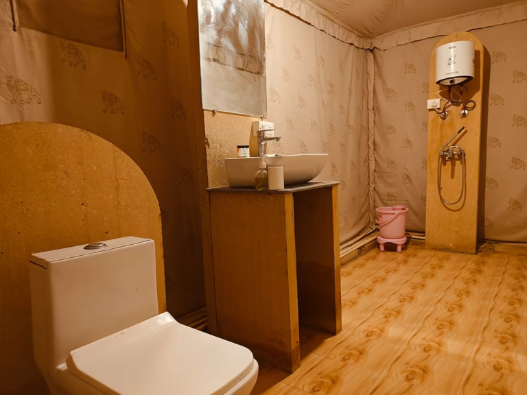 Attached bathroom with toilet and washbasin in the Super Deluxe Swiss Tent