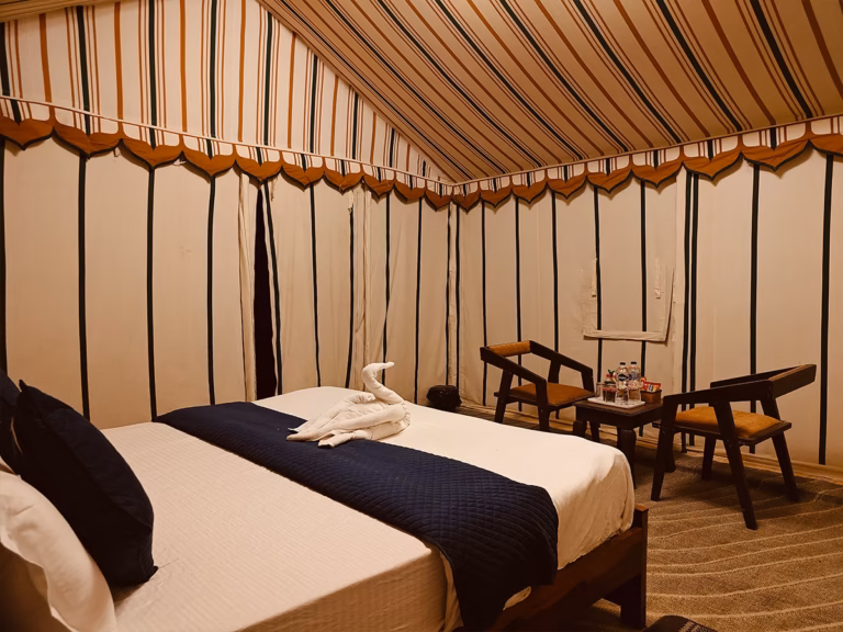 Deluxe Swiss Tent with king bed and indoor seating area