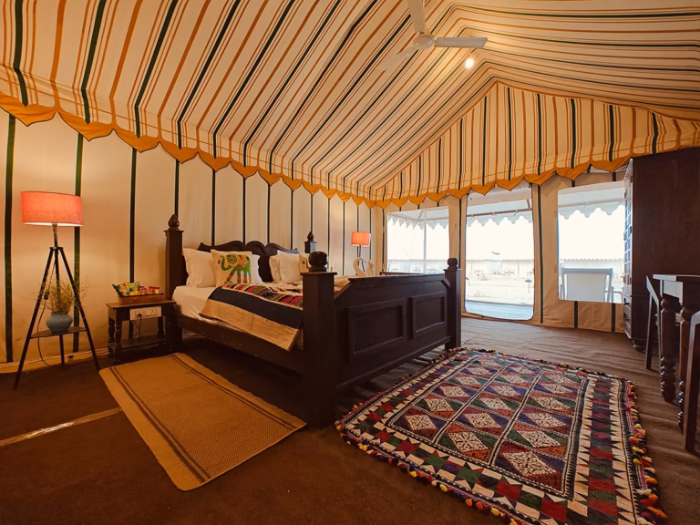 Wide interior view of the Luxury Swiss Tent with king bed and seating area