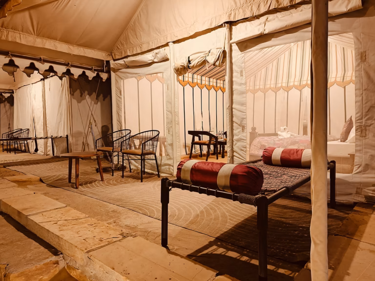Outdoor seating area outside the Super Deluxe Swiss Tent at Venture Desert Camp