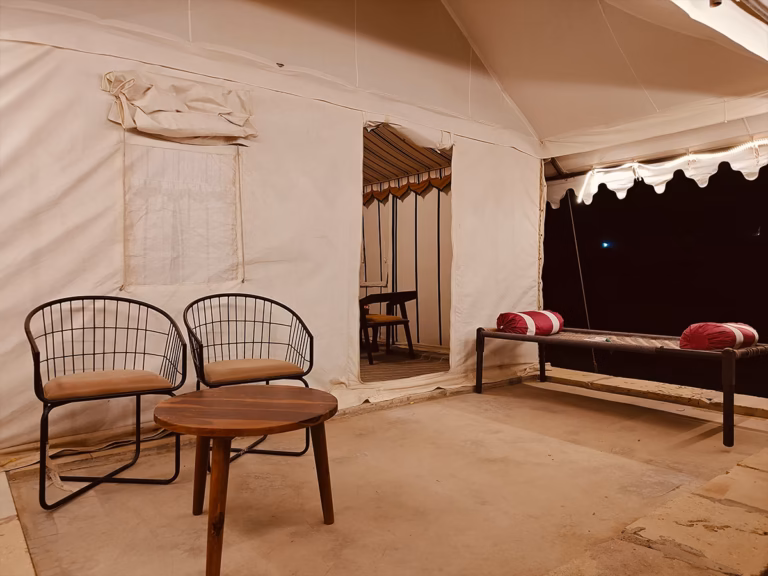 Outdoor seating area outside the Deluxe Swiss Tent at Venture Desert Camp