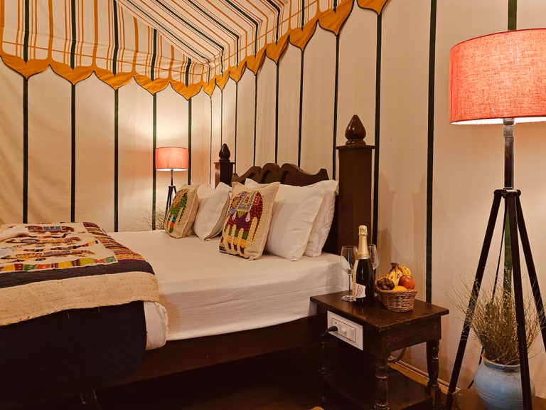 Wooden king bed with premium linen in the Luxury Swiss Tent