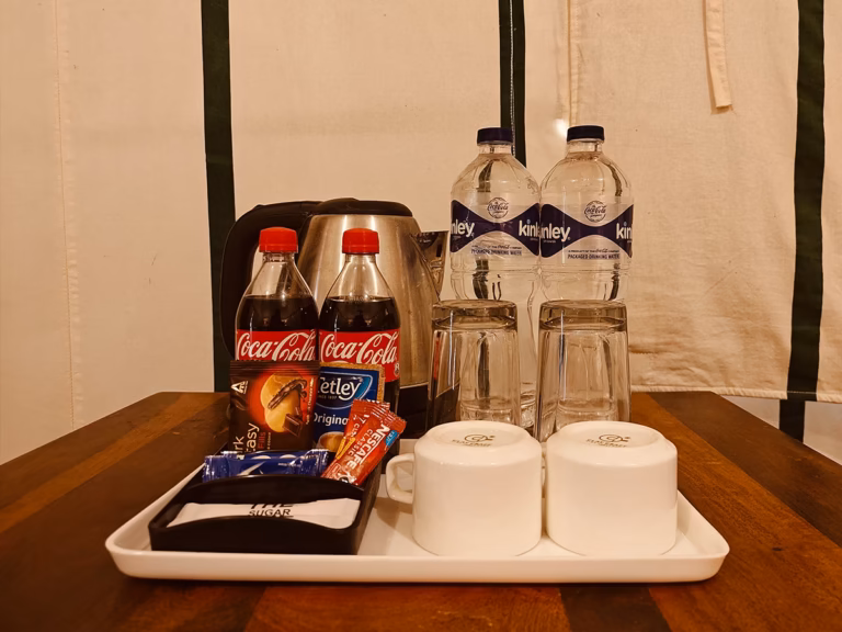 Tea, coffee and bottled water setup inside the Luxury Swiss Tent